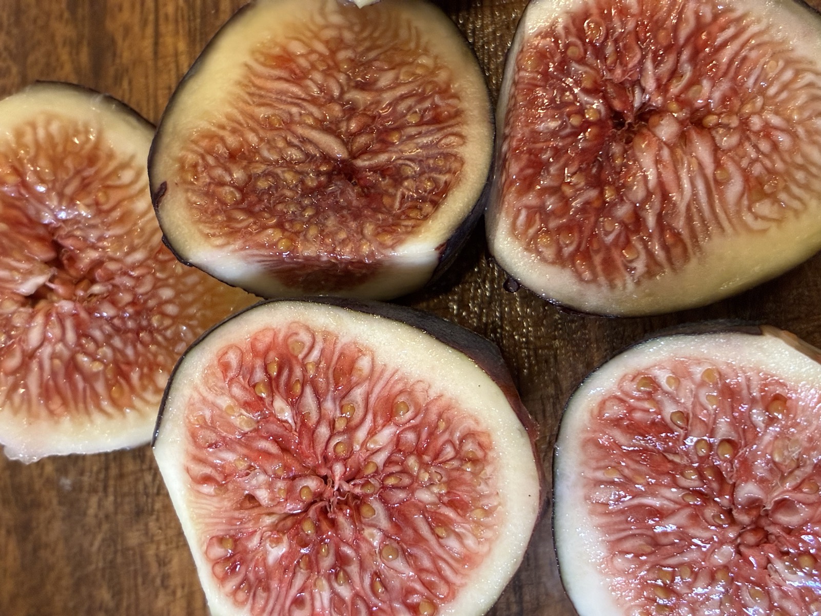Fresh figs halved on a cutting board